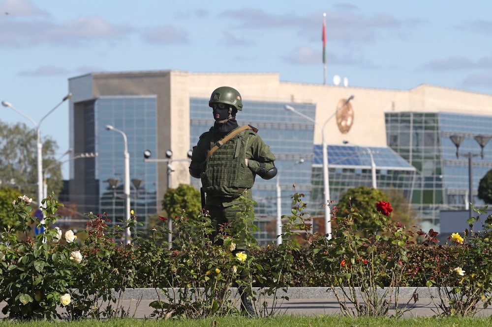 A riot police officer guards State Flag Square, with the Supreme Court building in the background, during mass protests against the presidential election results, in Minsk, Belarus, 20 September 2020, Valery Sharifulin/TASS via Getty Images