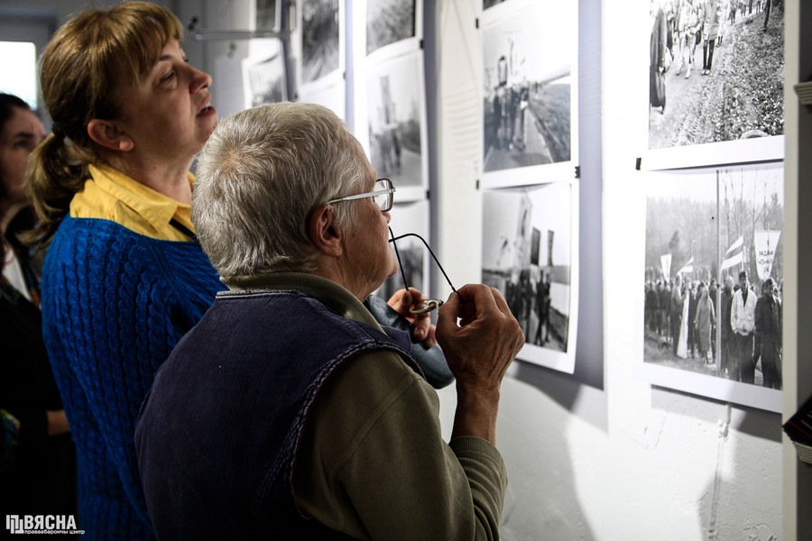 Вядомая абаронца Курпатаў Ніна Багінская разглядае фотаздымкі Уладзіміра Сапагова